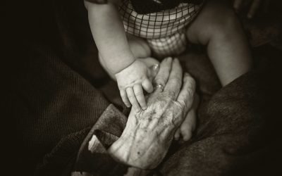 an older woman holding an older woman holding a baby's hand